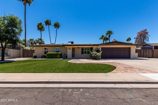 1535 E Kenwood St, Mesa, AZ 85203 - ranch-style house with concrete driveway, an attached garage, and brick siding
