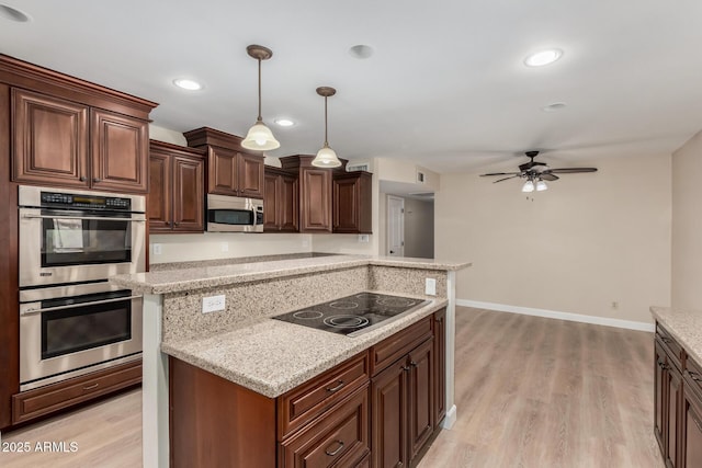 1535 E Kenwood St, Mesa, AZ 85203 - kitchen featuring stainless steel appliances, light wood-type flooring, ceiling fan, hanging light fixtures, and recessed lighting