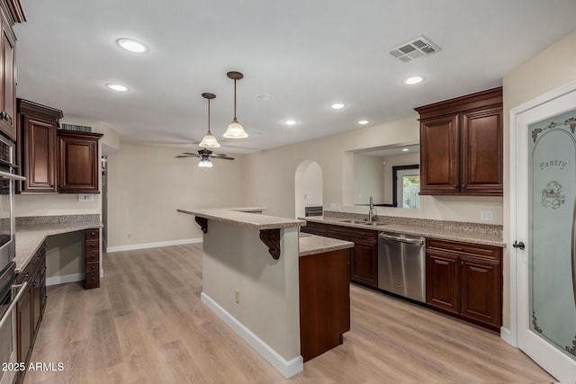 1535 E Kenwood St, Mesa, AZ 85203 - kitchen featuring stainless steel dishwasher, ceiling fan, light wood finished floors, hanging light fixtures, and a sink
