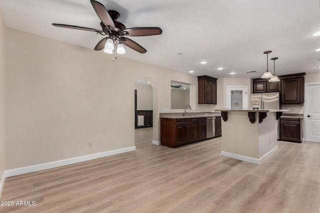 1535 E Kenwood St, Mesa, AZ 85203 - kitchen with a sink, appliances with stainless steel finishes, recessed lighting, ceiling fan, and arched walkways