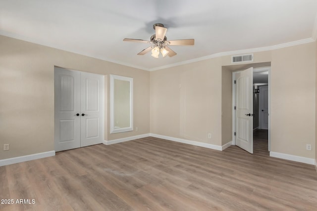 1535 E Kenwood St, Mesa, AZ 85203 - unfurnished bedroom featuring ornamental molding, baseboards, light wood finished floors, a closet, and ceiling fan