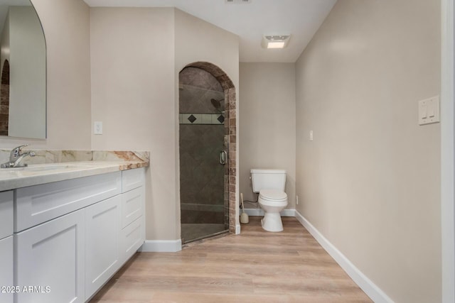 1535 E Kenwood St, Mesa, AZ 85203 - bathroom with toilet, a shower stall, wood finished floors, baseboards, and vanity