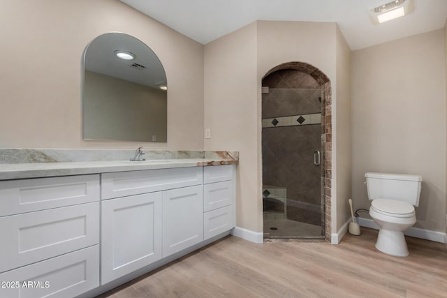 1535 E Kenwood St, Mesa, AZ 85203 - full bathroom with toilet, wood finished floors, a shower stall, baseboards, and vanity
