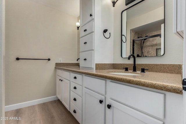 1535 E Kenwood St, Mesa, AZ 85203 - bathroom with double vanity, a stall shower, wood finished floors, and baseboards