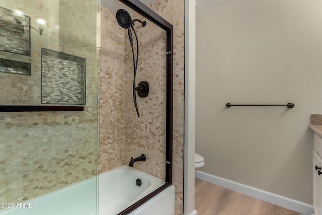 1535 E Kenwood St, Mesa, AZ 85203 - full bathroom with wood finished floors, enclosed tub / shower combo, baseboards, toilet, and vanity