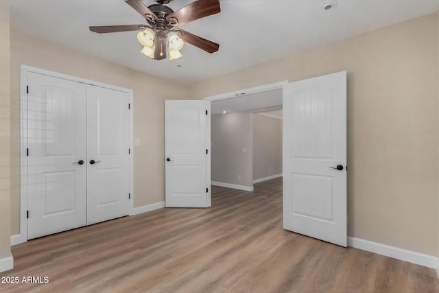 1535 E Kenwood St, Mesa, AZ 85203 - unfurnished bedroom featuring baseboards, light wood finished floors, and a closet