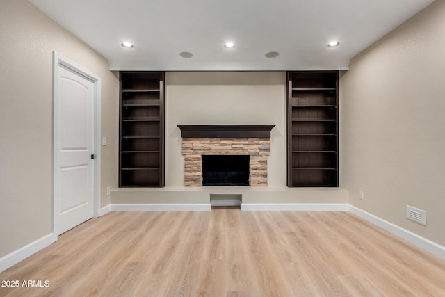 1535 E Kenwood St, Mesa, AZ 85203 - unfurnished living room with built in shelves, wood finished floors, baseboards, and recessed lighting