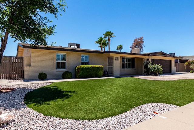 1535 E Kenwood St, Mesa, AZ 85203 - ranch-style home with an attached garage, concrete driveway, and a chimney