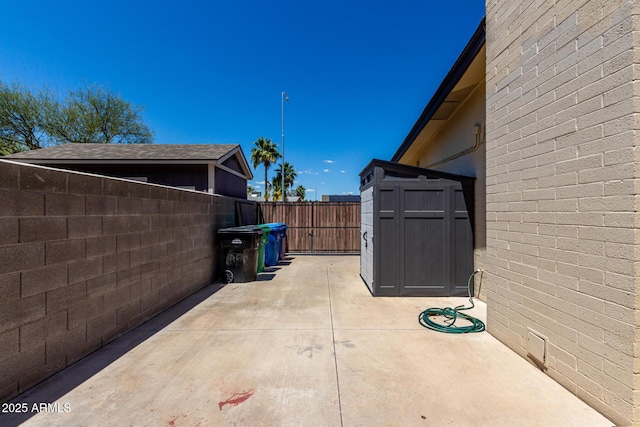 1535 E Kenwood St, Mesa, AZ 85203 - view of patio / terrace with a storage shed, an outdoor structure, and a fenced backyard