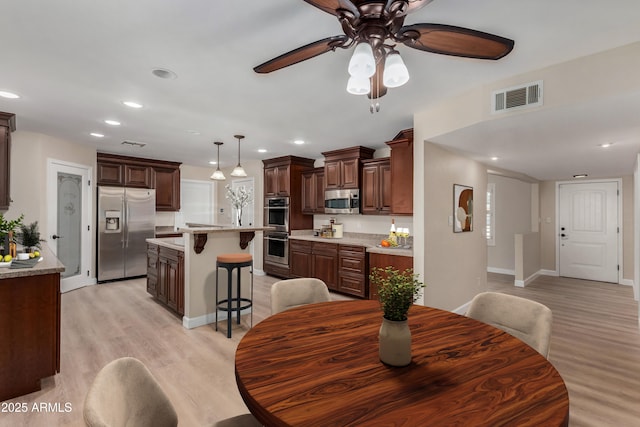 1535 E Kenwood St, Mesa, AZ 85203 - dining room featuring light wood-type flooring, ceiling fan, recessed lighting, and baseboards