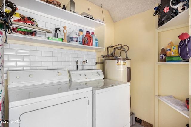 laundry room with laundry area, water heater, a textured ceiling, and independent washer and dryer