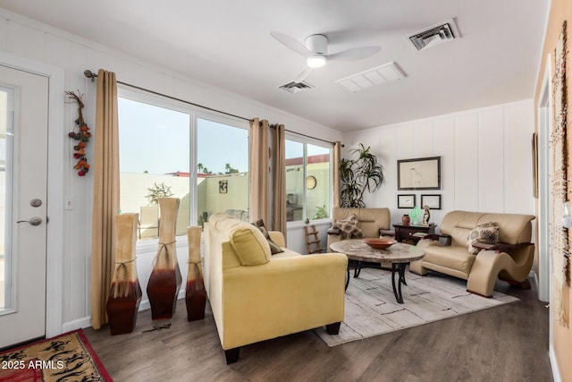 interior space with wood finished floors, visible vents, and a ceiling fan