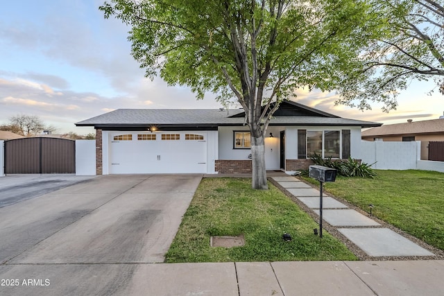 single story home featuring an attached garage, brick siding, fence, a lawn, and a gate