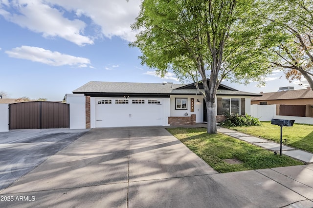 ranch-style home with concrete driveway, an attached garage, a gate, fence, and brick siding