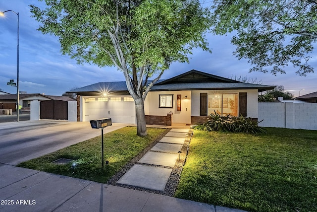 ranch-style home with a garage, brick siding, fence, a yard, and driveway