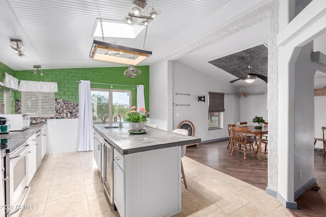 23948 W Jomax Rd, Wittmann, AZ 85361 - kitchen featuring vaulted ceiling, a sink, white cabinets, appliances with stainless steel finishes, and a ceiling fan