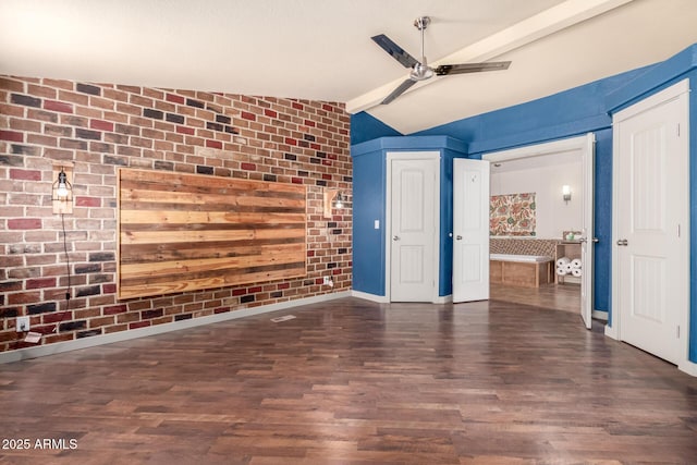 23948 W Jomax Rd, Wittmann, AZ 85361 - unfurnished living room featuring ceiling fan, lofted ceiling, wood finished floors, brick wall, and baseboards