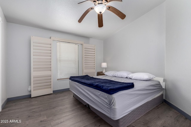 23948 W Jomax Rd, Wittmann, AZ 85361 - bedroom with wood finished floors, baseboards, lofted ceiling, and ceiling fan