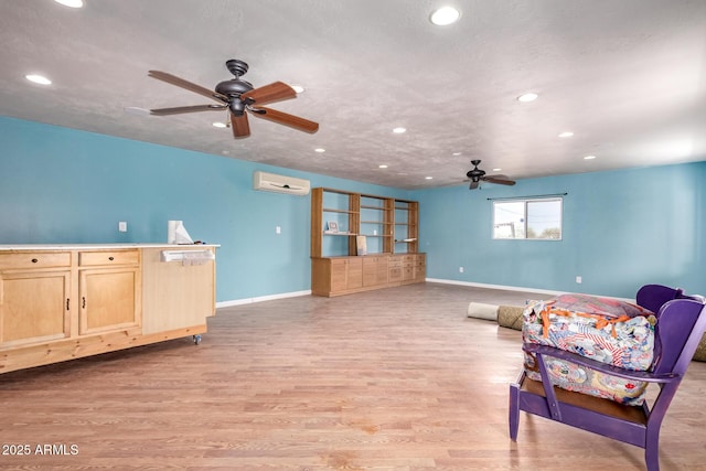 23948 W Jomax Rd, Wittmann, AZ 85361 - living area with a ceiling fan, a wall unit AC, baseboards, recessed lighting, and light wood-type flooring