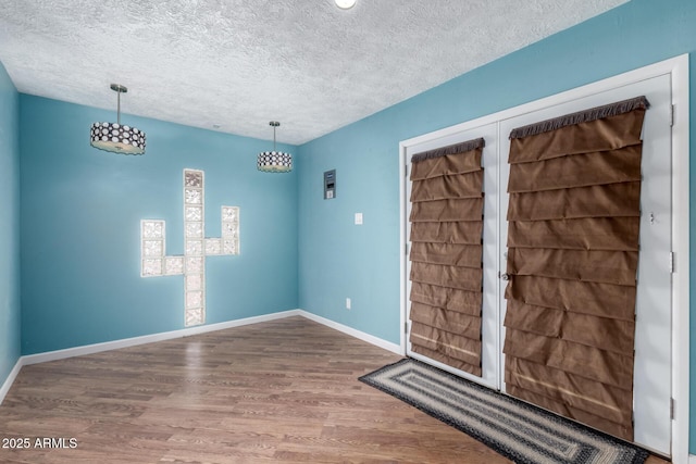 23948 W Jomax Rd, Wittmann, AZ 85361 - foyer entrance with a textured ceiling, wood finished floors, and baseboards