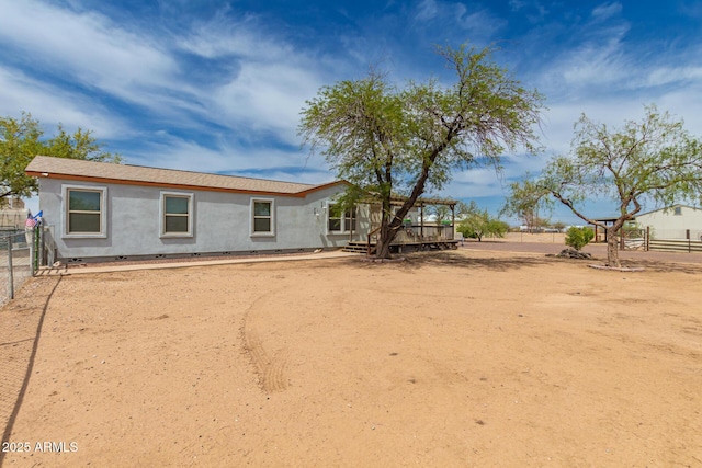23948 W Jomax Rd, Wittmann, AZ 85361 - back of property with a wooden deck, a fenced backyard, and stucco siding