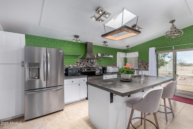 23948 W Jomax Rd, Wittmann, AZ 85361 - kitchen featuring appliances with stainless steel finishes, wall chimney exhaust hood, dark countertops, a sink, and white cabinets