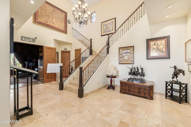 stairs featuring a chandelier and a high ceiling