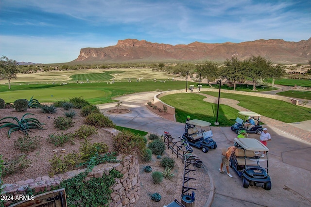 view of home's community with a mountain view and a yard