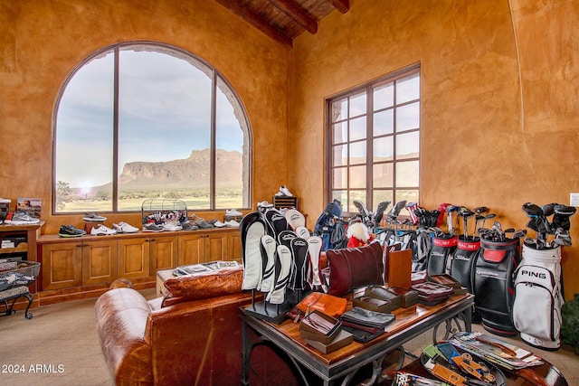 carpeted home office with beam ceiling, a mountain view, plenty of natural light, and wooden ceiling