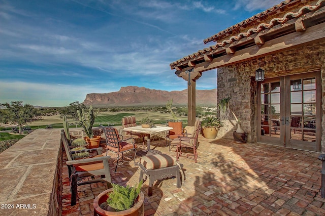 view of patio with a mountain view and french doors