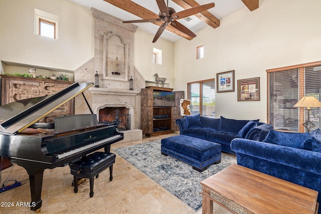 living room with a fireplace, beam ceiling, ceiling fan, and a high ceiling