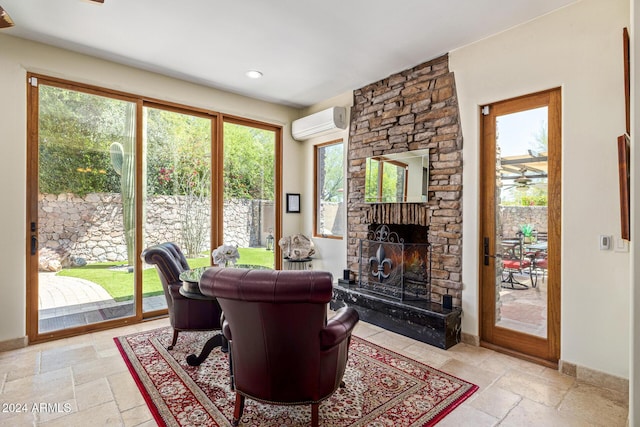 living room with a fireplace and a wall mounted air conditioner