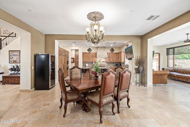 dining area with ceiling fan with notable chandelier