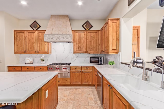 kitchen with stove, premium range hood, tasteful backsplash, and sink