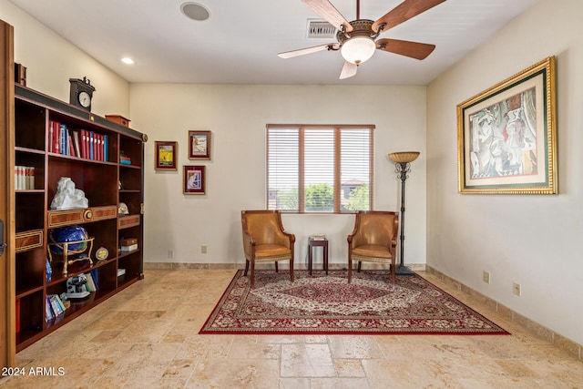 living area featuring ceiling fan