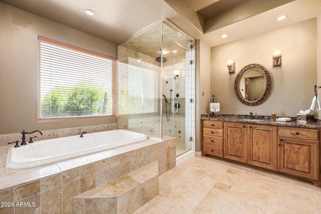 bathroom featuring vanity, plenty of natural light, and plus walk in shower