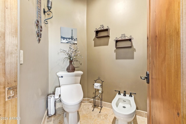 bathroom with toilet and a bidet