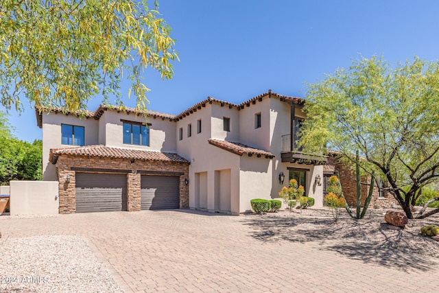 mediterranean / spanish-style home with a garage