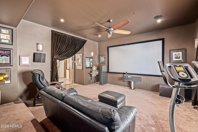 carpeted cinema room with ceiling fan