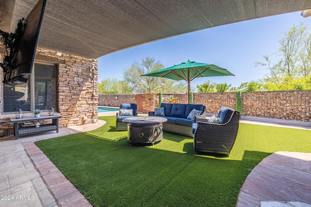 view of yard with an outdoor living space, a fenced in pool, and a patio area