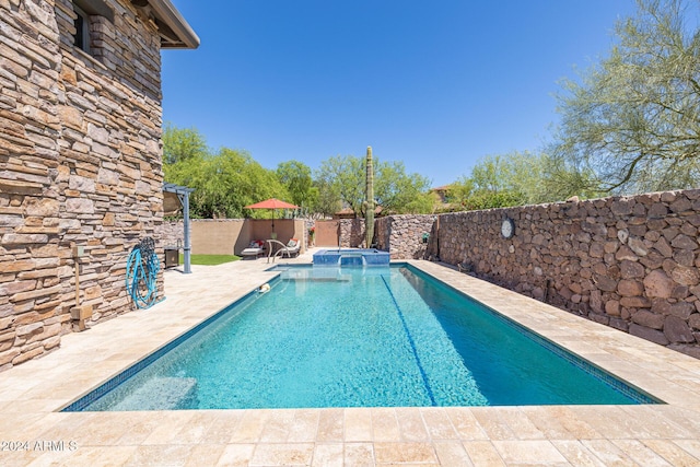 view of pool featuring an in ground hot tub and a patio