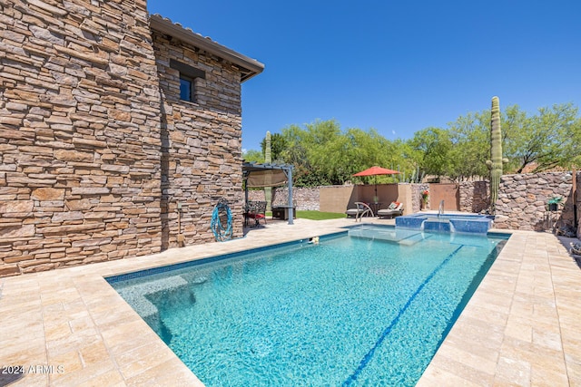 view of pool with a patio area and an in ground hot tub