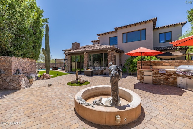 view of patio / terrace featuring a grill and exterior kitchen