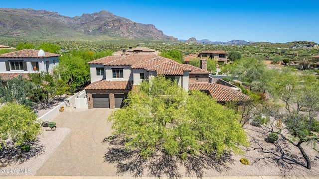 view of front of home featuring a mountain view and a garage