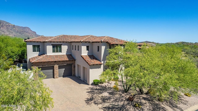 mediterranean / spanish house with a mountain view and a garage