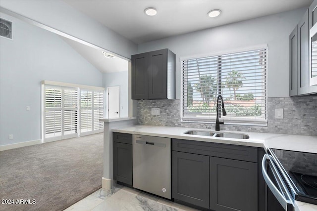 kitchen featuring sink, light colored carpet, stainless steel dishwasher, and plenty of natural light