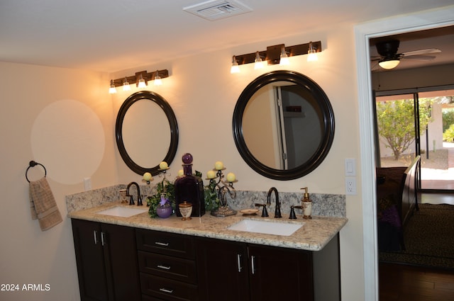 bathroom featuring ceiling fan, hardwood / wood-style floors, and vanity