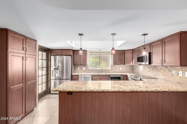 kitchen featuring sink, decorative light fixtures, light stone counters, kitchen peninsula, and stainless steel appliances