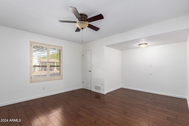 empty room with dark hardwood / wood-style flooring and ceiling fan