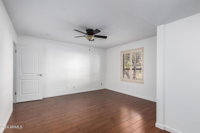 spare room with ceiling fan and dark hardwood / wood-style flooring